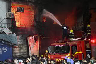 Firefighters douse a fire that broke out at a shopping mall in Karachi on January 18, 2026.  
