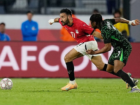 Egypt's Mohanad Lasheen, left, chases the ball with Nigeria's Ademola Lookman during the Africa Cup of Nations third place game in Casablanca, Morocco, Saturday, January 17, 2026.  