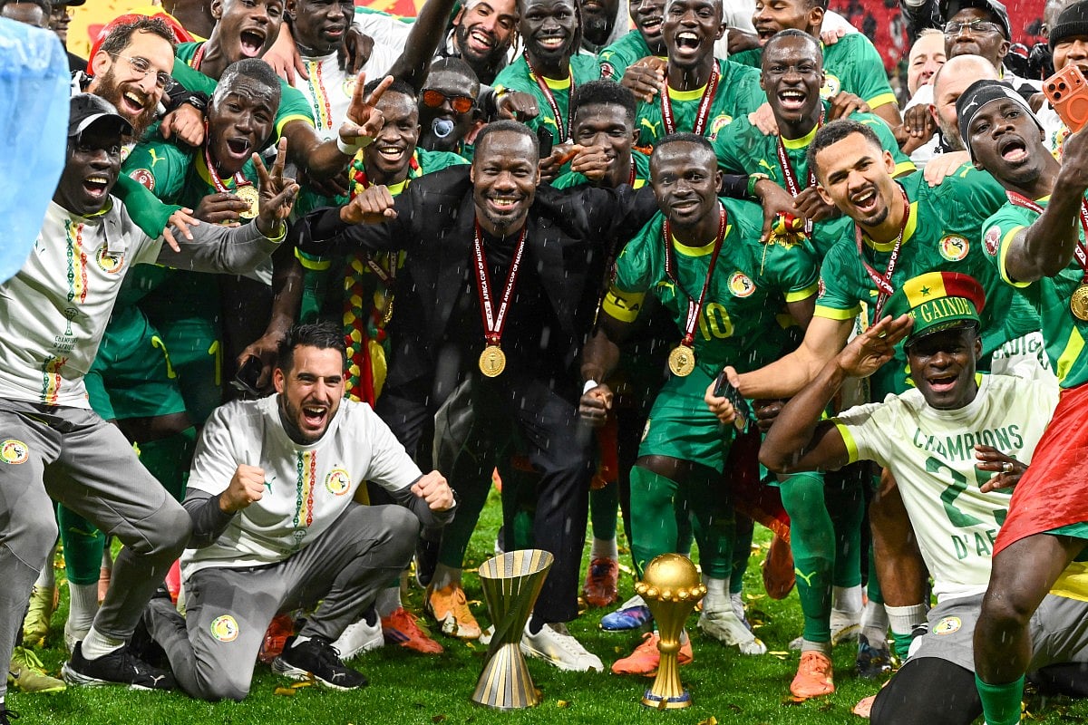 Senegal's head coach Pape Thiaw and Senegal's forward #10 Sadio Mane celebrate after winning the Africa Cup of Nations (CAN) final football match between Senegal and Morocco at the Prince Moulay Abdellah Stadium in Rabat on January 18, 2026.