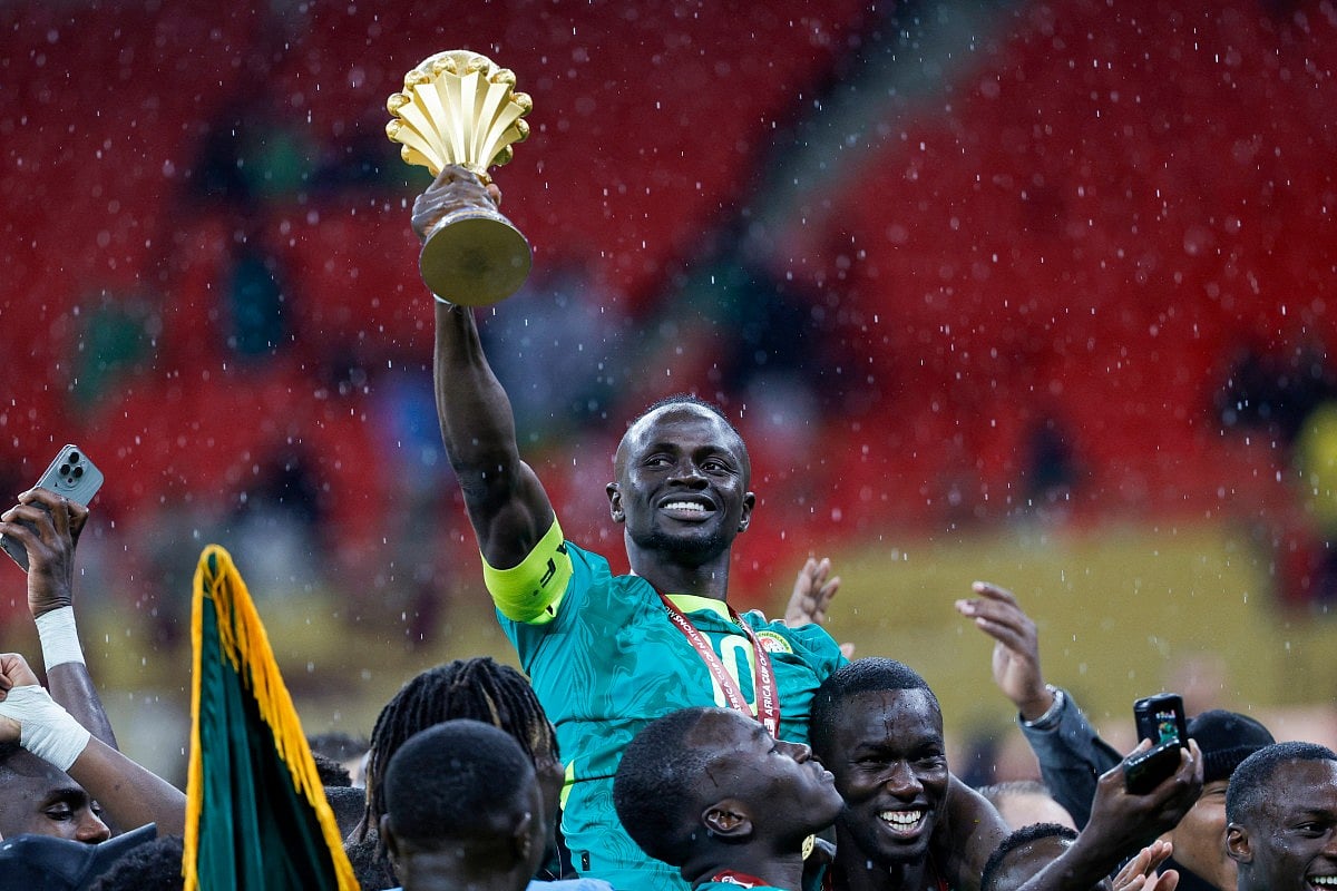 Senegal's forward #10 Sadio Mane holds up the trophy as he celebrates with his teammates after winning the Africa Cup of Nations (CAN) final football match against Morocco at the Prince Moulay Abdellah Stadium in Rabat on January 18, 2026.