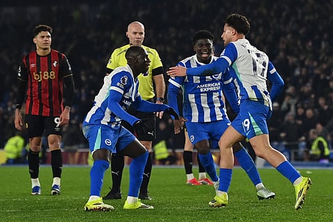Brighton's Greek striker #19 Charalampos Kostoulas (R) celebrates scoring the equalising goal with Brighton's Cameroonian midfielder #17 Carlos Baleba during the English Premier League football match between Brighton and Hove Albion and Bournemouth at the American Express Community Stadium in Brighton, southern England on January 19, 2026.