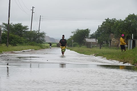 People walk through floodwaters in Nkomazi, Mpumalanga Province, South Africa, on Friday, Jan. 16, 2026. (AP Photo/Alfonso Nqunjana)