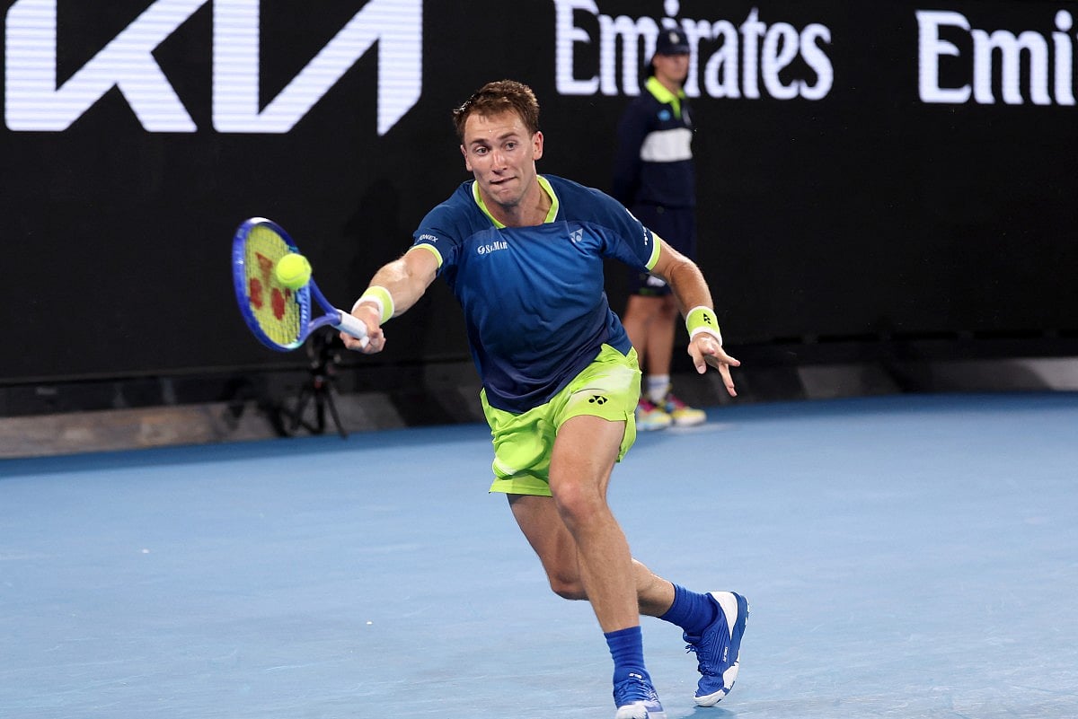 Norway's Casper Ruud hits a return to Italy's Mattia Bellucci during their men's singles match on day two of the Australian Open tennis tournament in Melbourne on January 19, 2026.