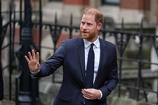 Britain's Prince Harry waves as he arrives at London's High Court to lead a group, including Elton John and Elizabeth Hurley, accusing the Daily Mail's publisher of privacy invasion through unlawful tactics in a trial that is part of a wider phone hacking scandal in London, Monday, Jan. 19, 2026. 