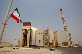 FILE - An Iranian flag flutters in front of the reactor building of the Bushehr nuclear power plant, just outside the southern city of Bushehr, Iran, Aug. 21, 2010. (AP Photo/Vahid Salemi, File)