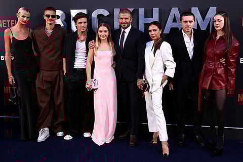 Former England footballer David Beckham (5th L) and his wife Victoria Beckham (3rd R) pose on the red carpet with their children and partners, (from L) Mia Regan, Romeo Beckham, Cruz Beckham, Harper Beckham, Brooklyn Beckham and Nicola Peltz Beckham upon arrival to attend the premiere of "Beckham" in London on October 3, 2023.