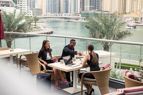 Businesspeople having a meeting outdoors.