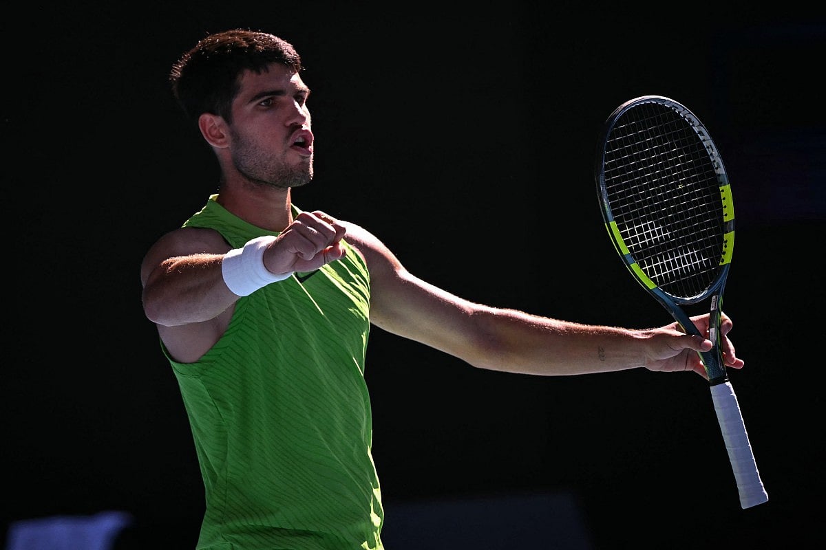 Spain's Carlos Alcaraz celebrates after winning against Germany's Yannick Hanfmann during their men's singles match on day four of the Australian Open tennis tournament in Melbourne on January 21, 2026.