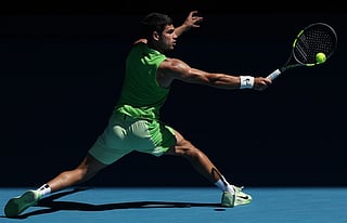 Alcaraz survives longest first set of his career at a major to move into Aus Open third round