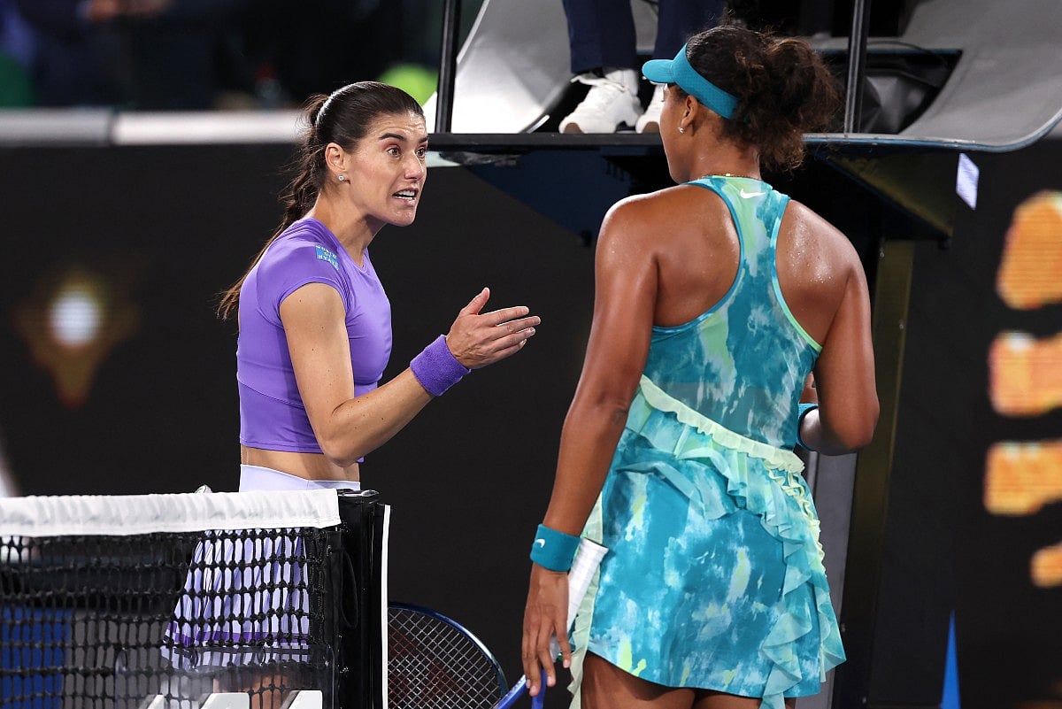 Romania's Sorana Cirstea talks with Japan's Naomi Osaka (R) following their second-round match on day five of the Australian Open tennis tournament in Melbourne on January 22, 2026.