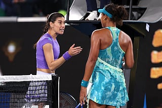 Romania's Sorana Cirstea talks with Japan's Naomi Osaka (R) following their second-round match on day five of the Australian Open tennis tournament in Melbourne on January 22, 2026.
