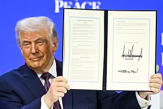 US President Donald Trump holds a signed founding charter at the "Board of Peace" meeting during the World Economic Forum (WEF) annual meeting in Davos on January 22, 2026.