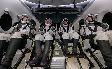 Roscosmos cosmonaut Oleg Platonov, left, NASA astronauts Mike Fincke, Zena Cardman, and JAXA (Japan Aerospace Exploration Agency) astronaut Kimiya Yui are seen inside the SpaceX Dragon Endeavour spacecraft onboard the SpaceX recovery ship Shannon shortly after having landed in the Pacific Ocean off the coast of Long Beach, Calif., Thursday, Jan. 15, 2026.