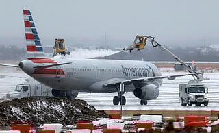 Ground crews de-ice an American Airlines jet at Dallas Fort Worth International Airport on January 24, 2026 in Dallas, Texas.
