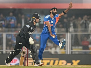 India's Jasprit Bumrah (R) bowls during the third T20I against New Zealand at the Barsapara Cricket Stadium in Guwahati on January 25, 2026. 