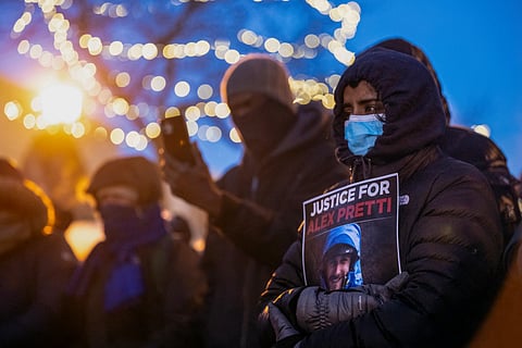 People mourn at a makeshift memorial in the area where 37-year-old Alex Pretti was shot dead by federal immigration agents earlier in the day in Minneapolis, Minnesota, on January 24, 2026.