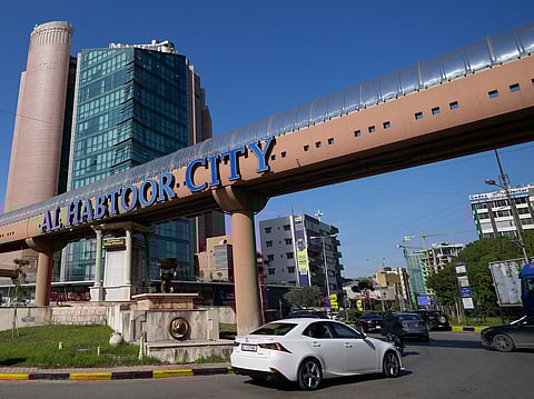 Cars pass next to Habtoor hotel, left, in Beirut, Lebanon 