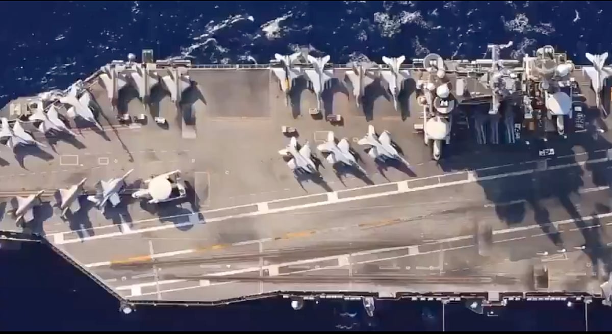 A top view showing an array of aircraft on the flight deck of the Nimitz-class aircraft carrier USS Abraham Lincoln during deployment en route to the Middle East.