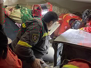 Rescuers search for survivors at a collapsed residential building in Tripoli.