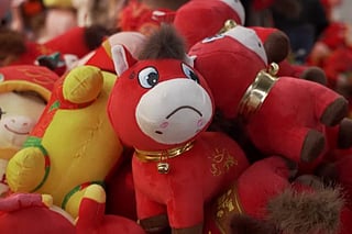 A red plush horse meant to smile cheerfully is now selling out across China.