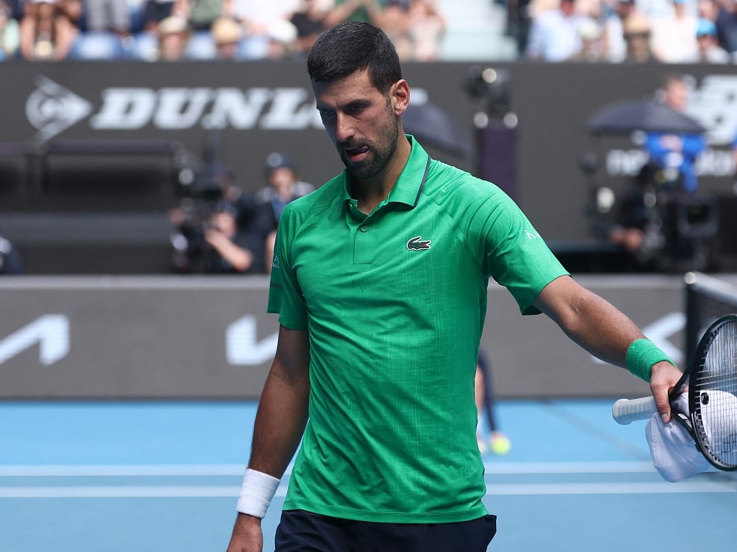 Serbia’s Novak Djokovic reacts after Italy’s Lorenzo Musetti retired injured during their men’s singles quarter-final match on day eleven of the Australian Open tennis tournament in Melbourne on January 28, 2026.