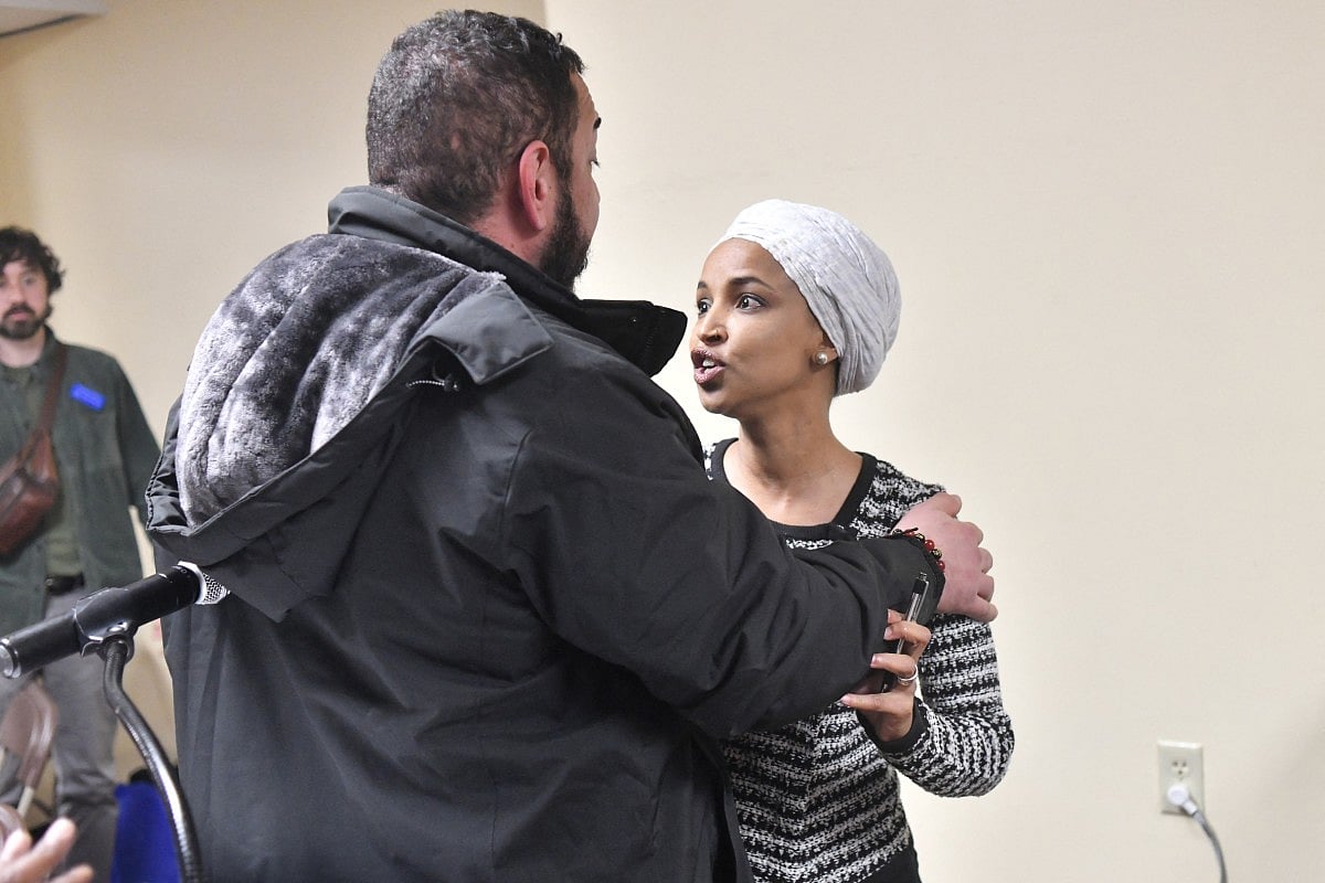 US Representative Ilhan Omar (D-MN) (R) reacts after being sprayed with an unknown substance by a man as she hosted a town hall in Minneapolis, Minnesota, on January 27, 2026.