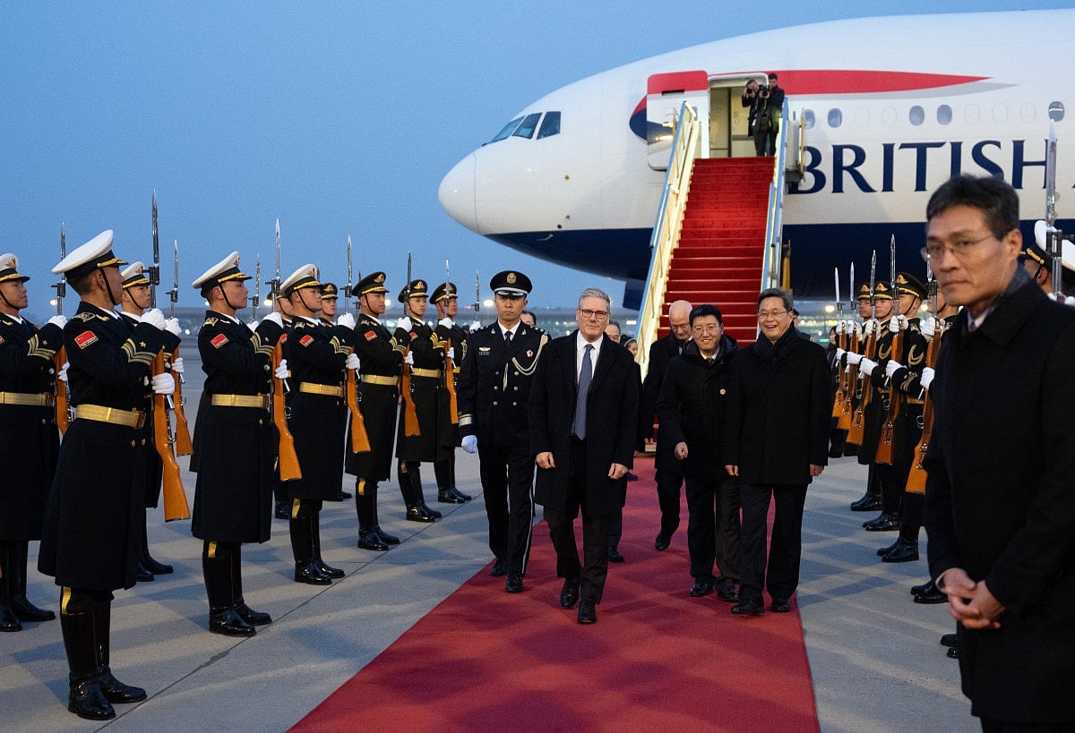 Britain's Prime Minister Keir Starmer is welcomed upon his arrival at an airport in Beijing on January 28, 2026.