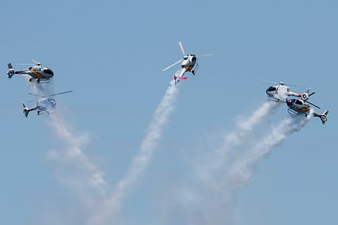 Helicopters from the Spanish Air and Space Force's ASPA patrol perform an aerial display over Ipanema Beach in Rio de Janeiro, Brazil.