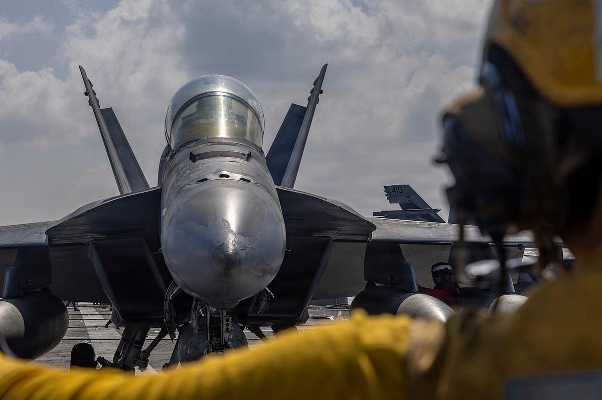 Aviation Boatswain's Mate 2nd Class Michael Cordova directing an F/A-18F Super Hornet on the flight deck of the Nimitz-class aircraft carrier USS Abraham Lincoln in the Indian Ocean on January 23, 2026 