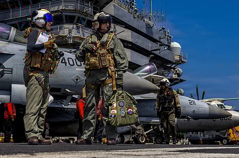 This handout image from the US Navy shows Capt. Daniel Keeler, the commanding officer of the Nimitz-class aircraft carrier USS Abraham Lincoln, as he prepares to fly an MH-60R Sea Hawk helicopter in the Indian Ocean on Jan. 23, 2026. 