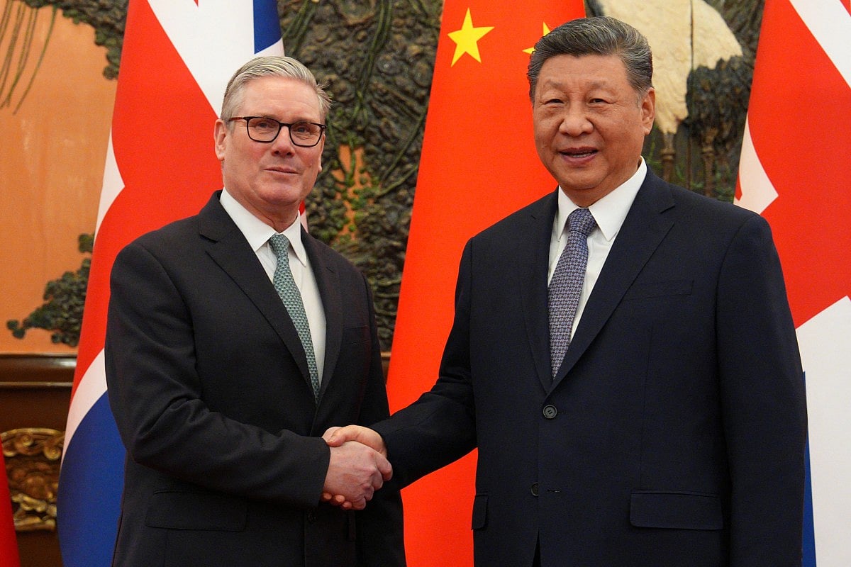 China's President Xi Jinping (R) and Britain's Prime Minister Keir Starmer shake hands before their meeting at the Great Hall of the People in Beijing on January 29, 2026.