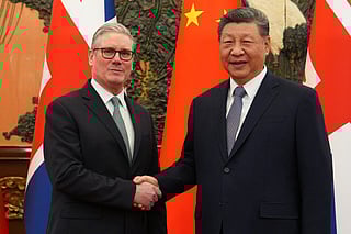 China's President Xi Jinping (R) and Britain's Prime Minister Keir Starmer shake hands before their meeting at the Great Hall of the People in Beijing on January 29, 2026.