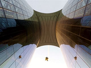 Wingsuit pilot Nicholas Scalabrino flies through Ciel Dubai Marina with his reflections seen on both sides of the glass-clad façade.