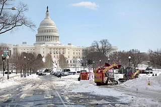 Crews work to clear snow on Pennsylvania Avenue near the US Capitol on January 28, 2026 in Washington, DC. Residents in Washington, DC are growing fustrated as many roads and sidewalks remain covered in snow and public schools remain closed for a third day.