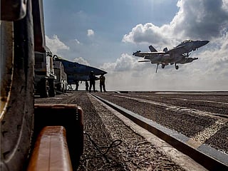 An EA-18G Growler landing on the flight deck of the Nimitz-class aircraft carrier USS Abraham Lincoln in the Indian Ocean. 