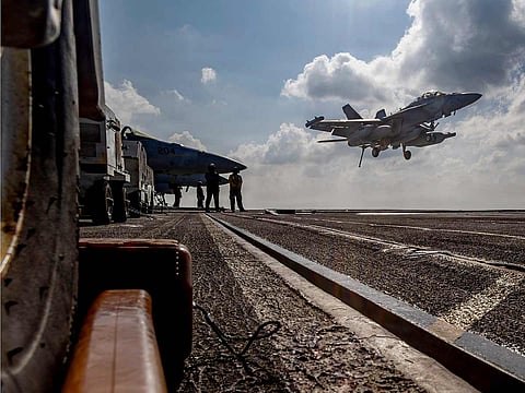 An EA-18G Growler landing on the flight deck of the Nimitz-class aircraft carrier USS Abraham Lincoln in the Indian Ocean. 