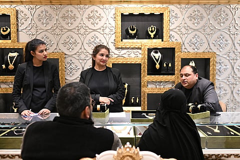 Customers buy gold necklaces at a jewellery store in New Delhi 
