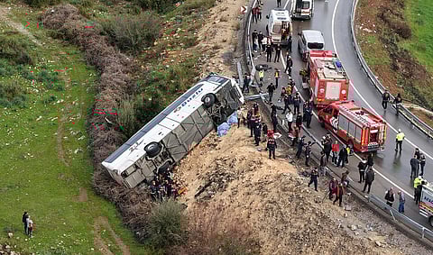 This handout photograph taken and released on February 1, 2026 by Turkish news agency DHA  shows an aerial view of a Bus accident where first aid official work in Antalya.