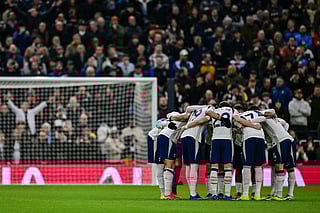 Spurs players huddle at the start of their Premier League match against Manchester City 