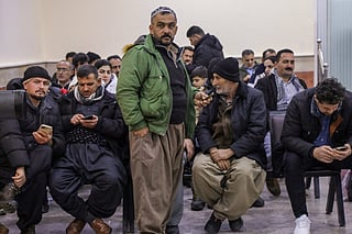 Mainly Iranian Kurds wait at the Haji Omran border crossing terminal with Iran, in Iraq's autonomous northern Kurdish region, on February 1, 2026, which is open to travellers and economic trade.