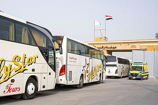 Buses line up to enter the Egyptian gate of the Rafah crossing into the Gaza Strip, in Rafah, Egypt, Monday, Feb. 2, 2026. 
