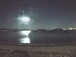 The luminous trail as it passed over the harbour, with the glow clearly reflected on the water’s surface.