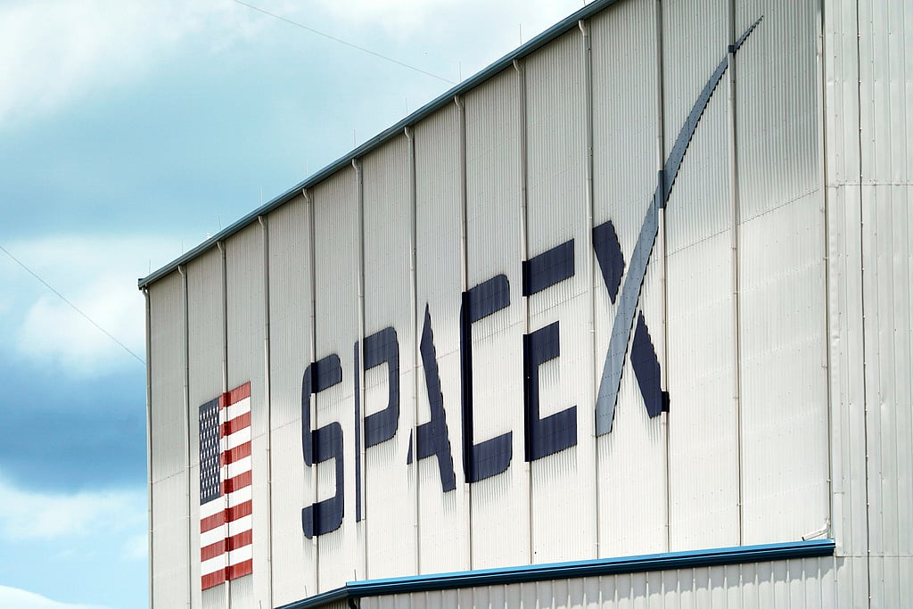 FILE - A SpaceX logo is displayed on a building, May 26, 2020, at the Kennedy Space Center in Cape Canaveral, Fla. (AP Photo/David J. Phillip, File)