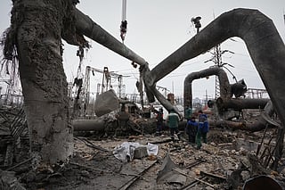 Workers clean up damage at Darnytsia Thermal Power Plant after a Russian attack in Kyiv, Ukraine, Wednesday, Feb. 4, 2026. (AP Photo/Sergei Grits)