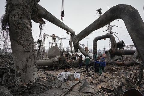 Workers clean up damage at Darnytsia Thermal Power Plant after a Russian attack in Kyiv, Ukraine, Wednesday, Feb. 4, 2026. (AP Photo/Sergei Grits)