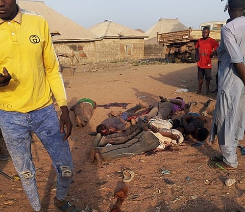This photo provided by Kaiama TV shows people gathered around victims killed by armed extremists in the Woro community of western Nigeria, Wednesday, Feb. 4, 2026. 