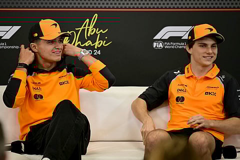 McLaren's British driver Lando Norris (L) and McLaren's Australian driver Oscar Piastri attend a press conference ahead of the Abu Dhabi Formula One Grand Prix at the Yas Marina Circuit in Abu Dhabi on December 4, 2025.