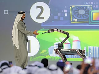 Sheikh Saif bin Zayed receives the chip from a robot at WGS on Thursday