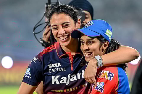 Royal Challengers Bengaluru's captain Smriti Mandhana and her Delhi Capitals' counterpart Jemimah Rodrigues share a light moment at the end of the Women's Premier League (WPL) Twenty20 final match at the Kotambi Stadium in Vadodara on February 5, 2026.