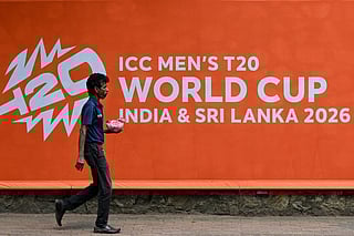 A man walks past a billboard advertising the 2026 ICC Men's T20 Cricket World Cup, at the Sinhalese Sports Club (SSC) cricket stadium in Colombo on February 5, 2026.